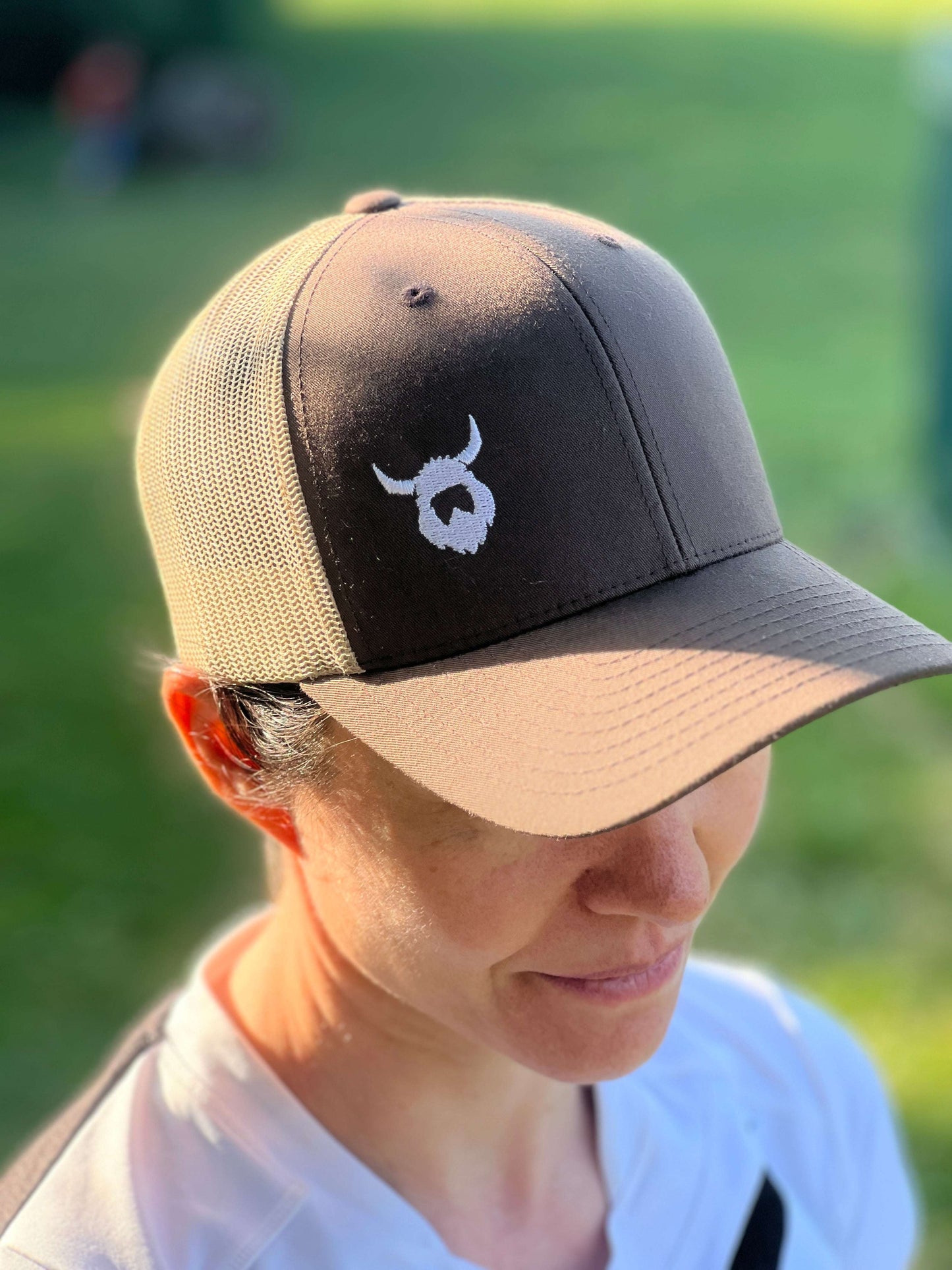 Brown Viking Trucker Cap with mesh back and embroidered Viking logo worn outdoors