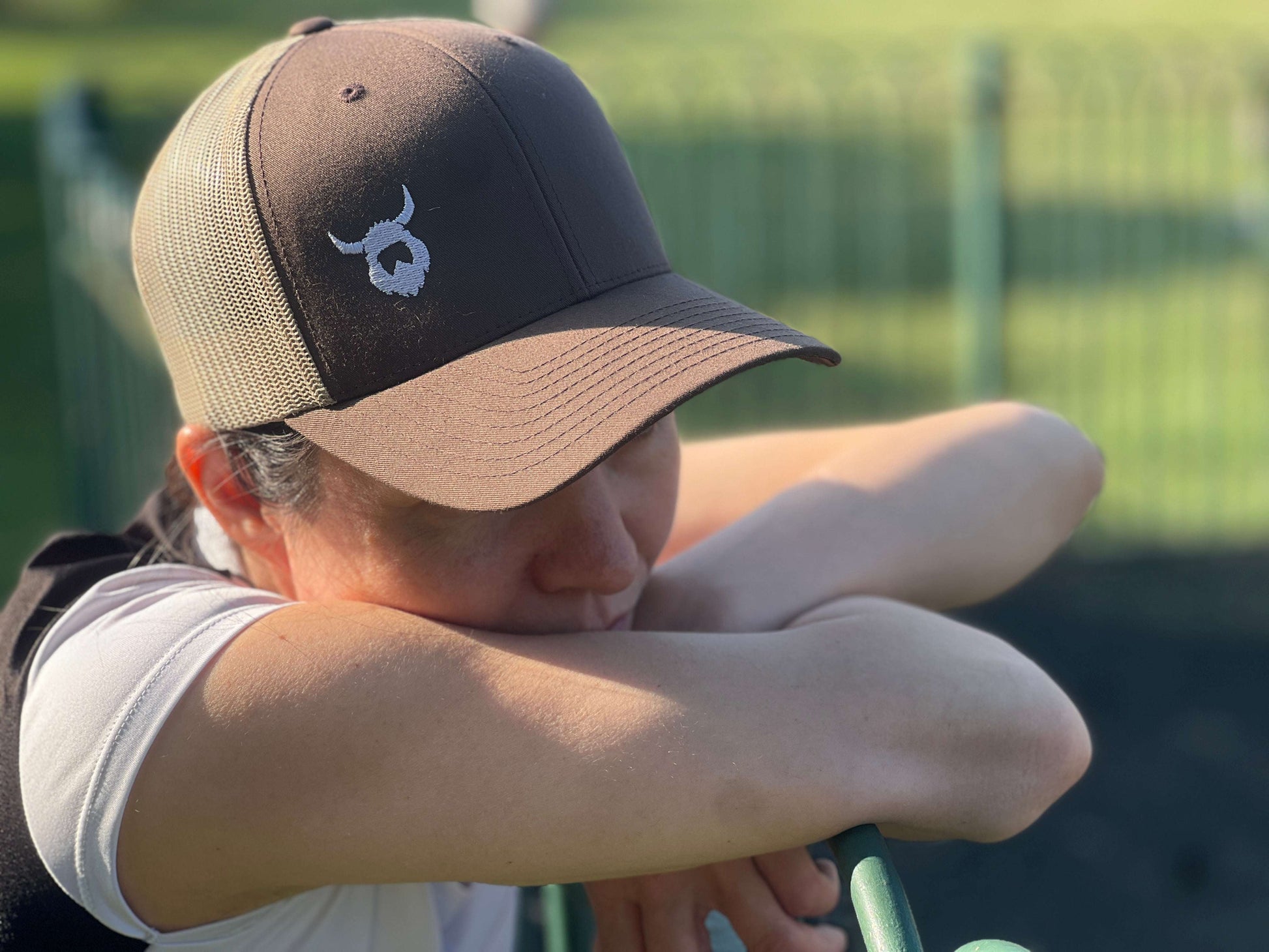 brown Viking Trucker Cap with mesh back and embroidered Viking logo worn outdoors