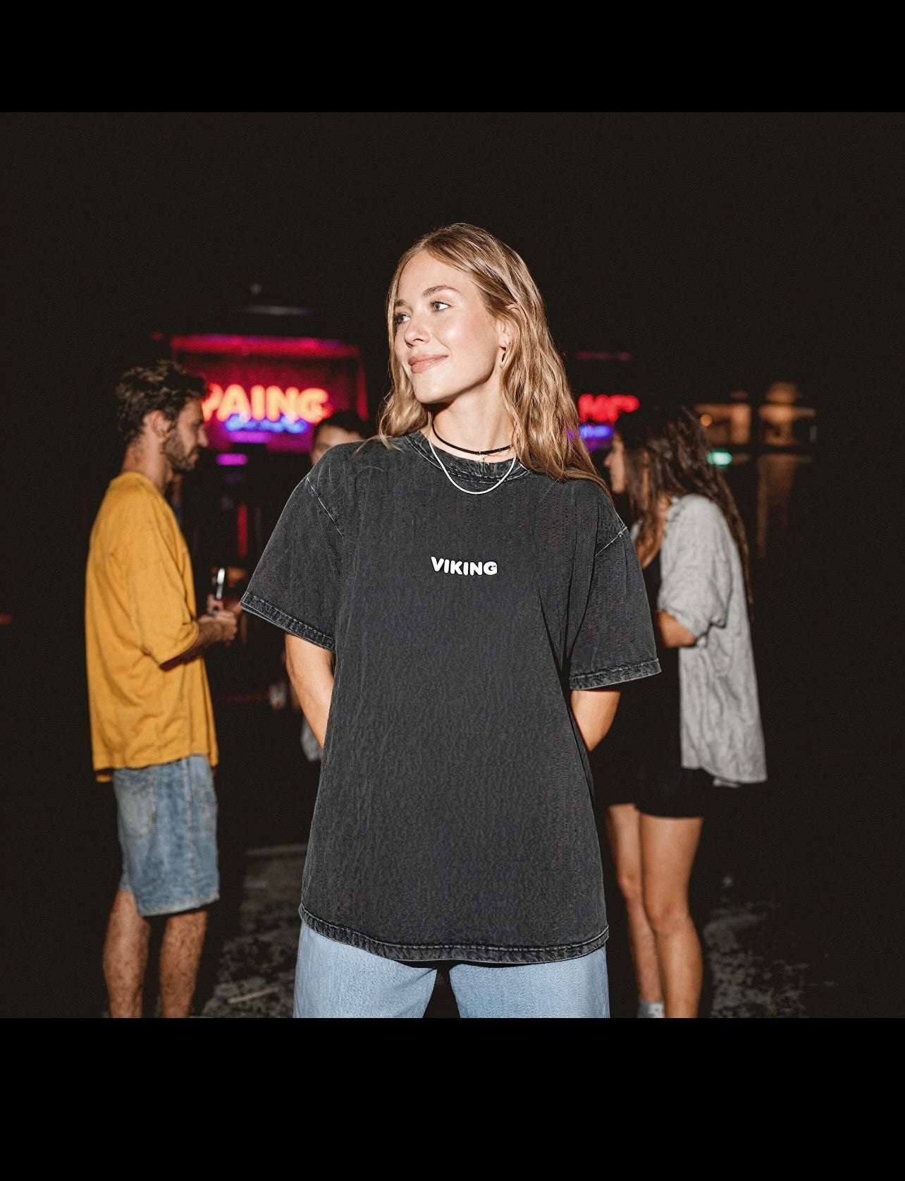 oversize snow wash viking t-shirt with stonewashed faded black fabric and relaxed fit on female model in casual night setting