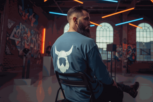 Man wearing blue long sleeve Viking shirt with Viking logo on back in urban setting