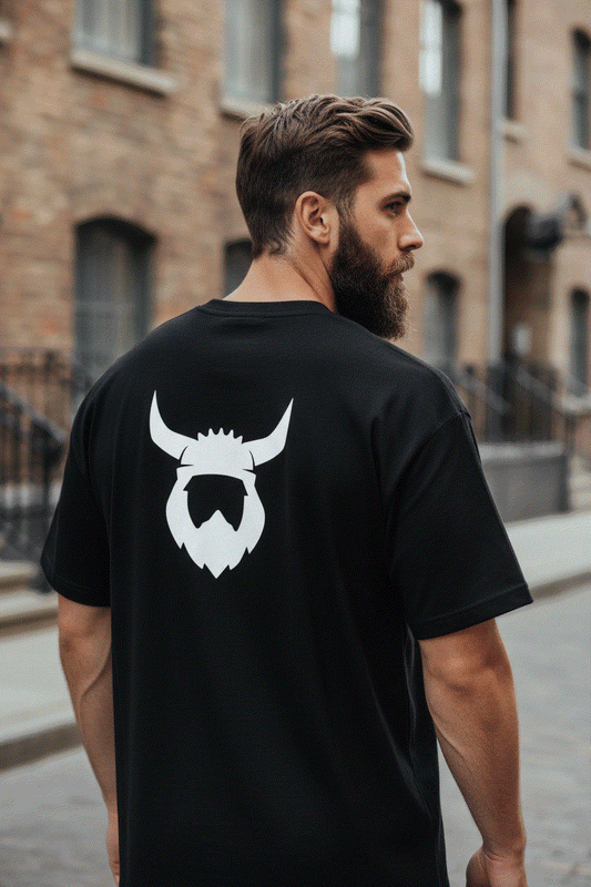 Bearded man showing back of Black Viking t-shirt with helmet logo