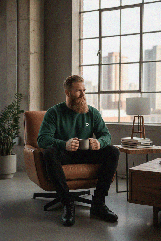 Bearded man with coffee wearing green Viking sweater in new urban setting