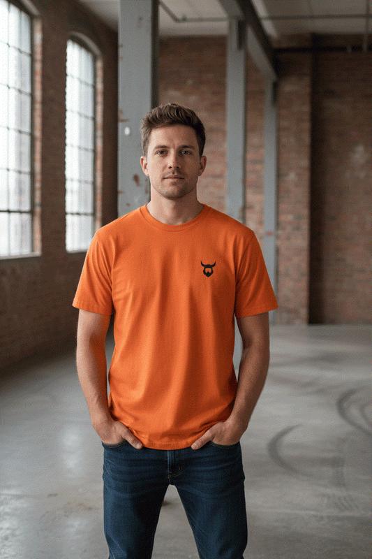 Man wearing orange Viking t-shirt in industrial setting
