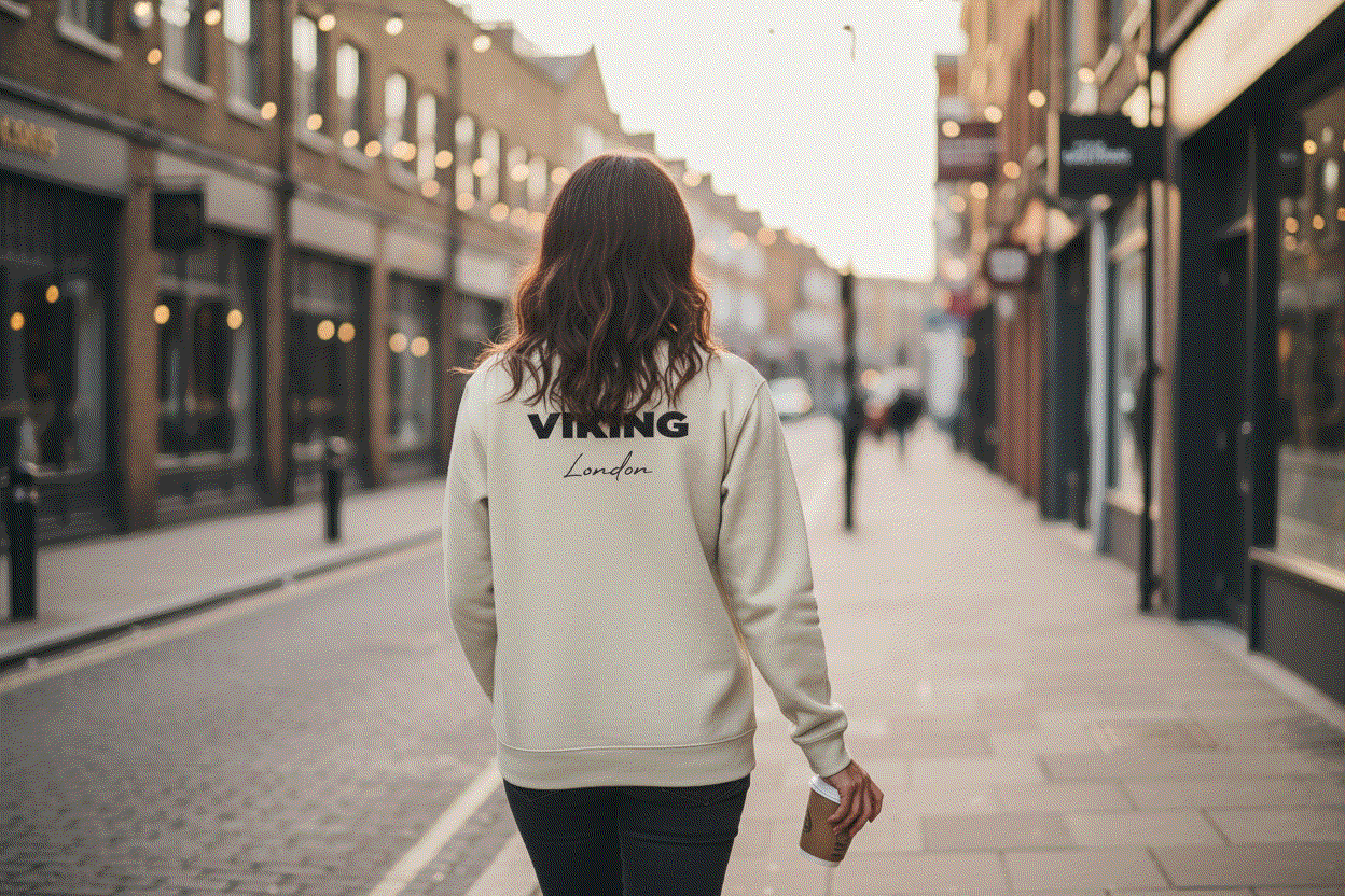 Woman walking away showing back of Light Viking Jumper